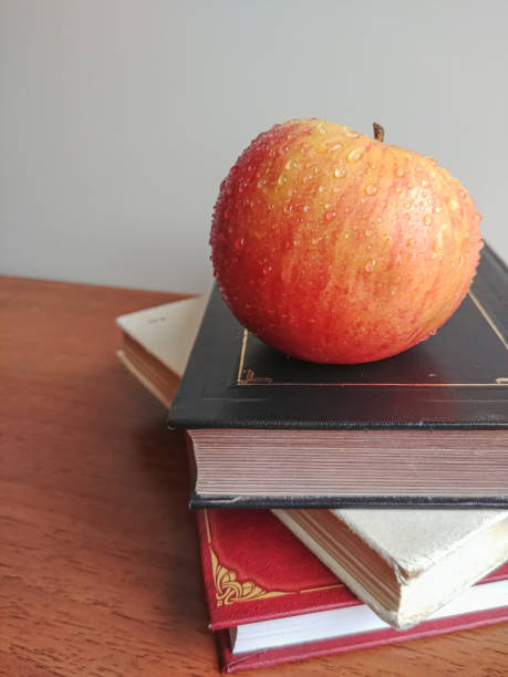 istock Pile stack of books with red apple on top, back to school concept 1302676693