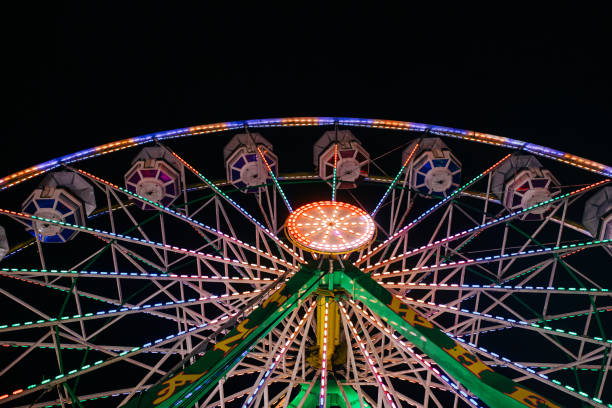 istock Ferris Wheel at Night with Colorful Lights for Carnival or Midway 1302677040