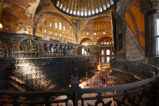 Istanbul, Turkey-June 9, 2013: Architectural Sections from the Interior of the Hagia Sophia Mosque, Columns, mosaics on the walls, dome decorations and large old chandeliers. A huge iron pier was built for the restoration.