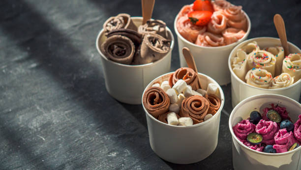 istock rolled ice creams in cone cups on dark background 1302678716
