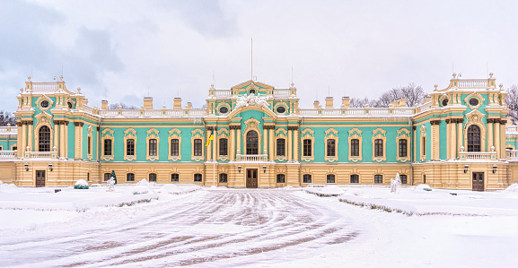 Kyiv, Ukraine - Fabruary 13, 2021: Facade and snow-covered courtyard of the Mariinsky Palace in Kiev. Ancient Baroque architecture and popular tourist attraction. Venue for celebrations and meetings by the President of Ukraine