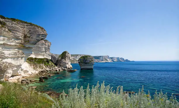 Blue Mediterranean sea in front of the Cliffs and town of Bonifacio on a beautiful spring day