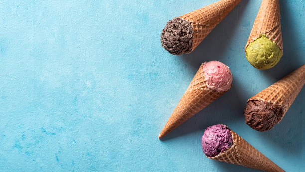istock ice cream scoops in cones with copy space on blue 1302679457