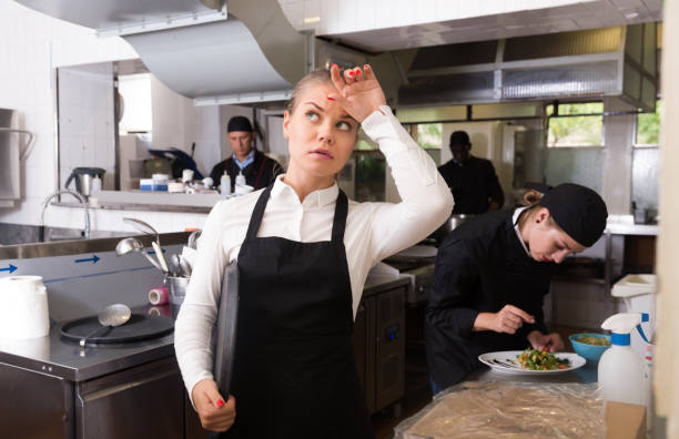 istock Upset waitress in kitchen of restaurant 1302679632