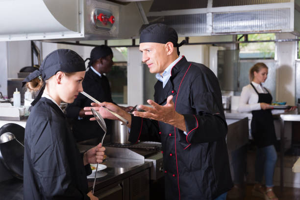 istock Exasperated chef scolding female employee 1302679655