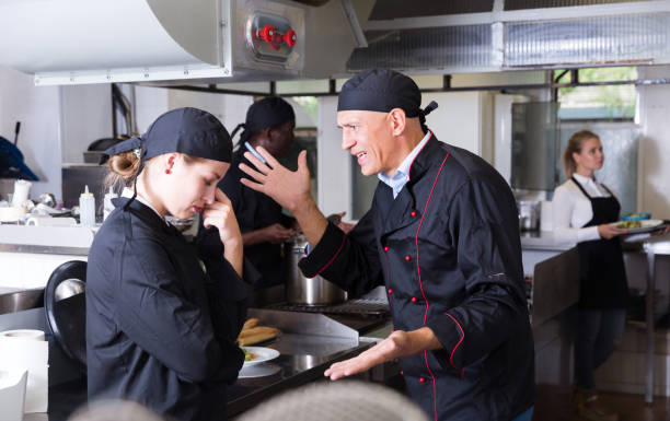 istock Exasperated chef scolding female employee 1302679662