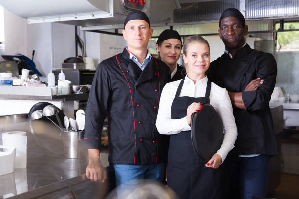 istock Group of chefs in kitchen of restaurant 1302679675