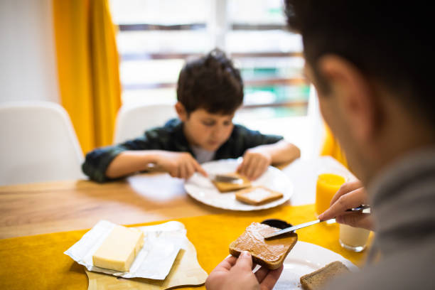 istock A young father spreading peanut butter over a slice of bread 1302680123