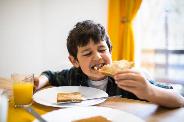 istock A cute boy eating toast 1302680152