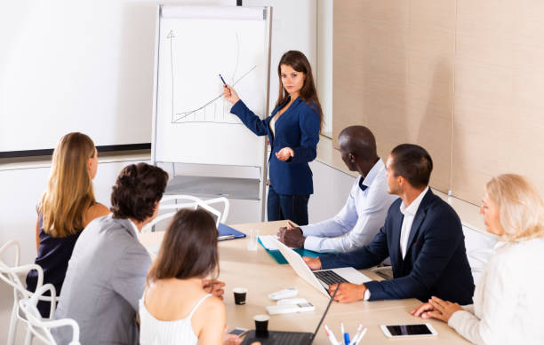 istock Woman reading out report to colleagues 1302680187