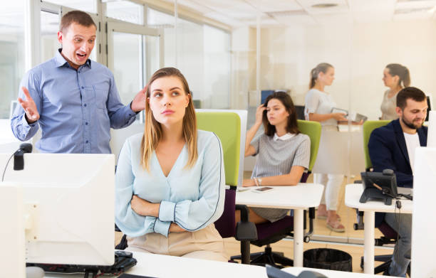 istock Irritated boss scolding female subordinate 1302680227