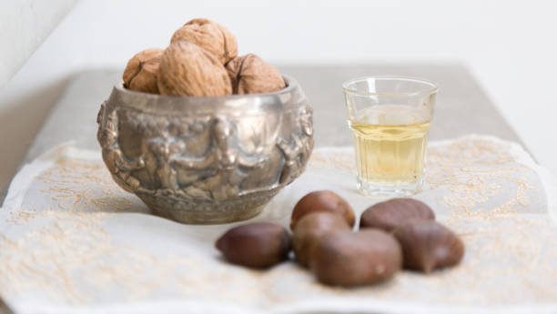 walnuts, chestnuts and a golden liquor glass on a concrete surface - whisky liqueur glass alcohol bottle imagens e fotografias de stock