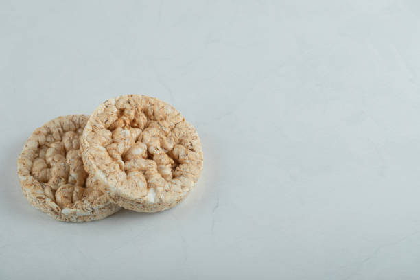 istock Tasty round crispbread on lighht gray background 1302681266