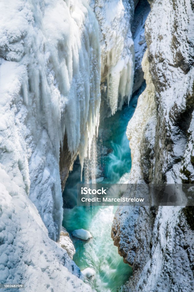 Partnachklamm Gorge in winter - frozen waterfalls over blue water Partnach Gorge Stock Photo