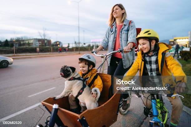 Family Biking In The City Stock Photo - Download Image Now - Cycling, Bicycle, Cargo Bike