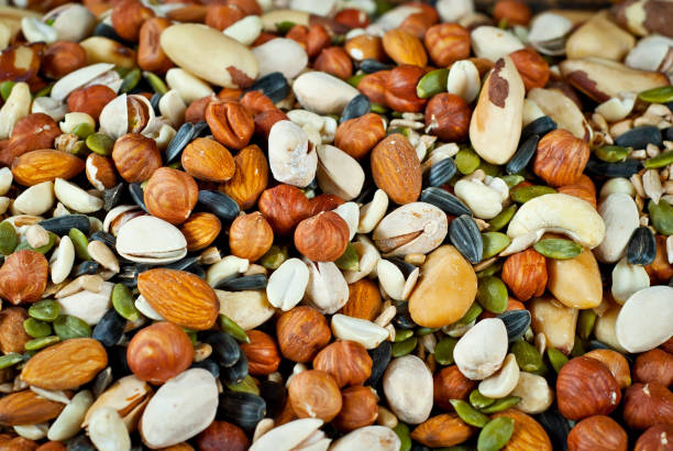 istock Many types of nuts close up. Textures of different nuts. Nuts are dumped in a pile. 1302683485