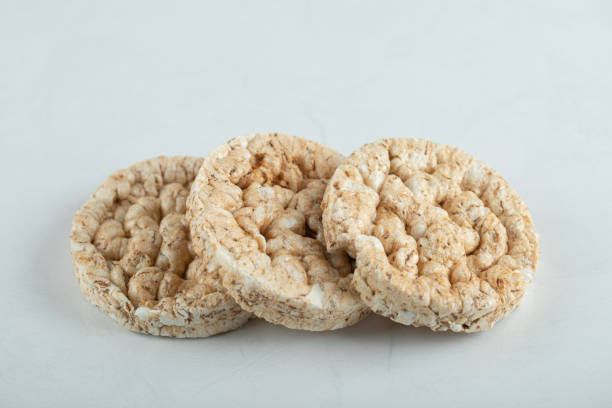 istock Tasty round crispbread on lighht gray background 1302684004