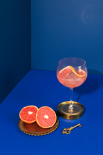 Pop Art Style Gin cocktail with Grapefruit Citrus Fruit in blue Background