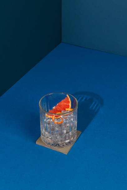 istock Pop Art Style Gin cocktail with Grapefruit Citrus Fruit in blue Background 1302684772