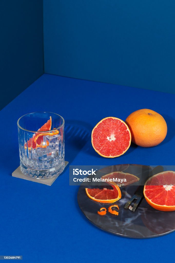 Pop Art Style Gin cocktail with Grapefruit Citrus Fruit in blue Background Gin Tonic Stock Photo