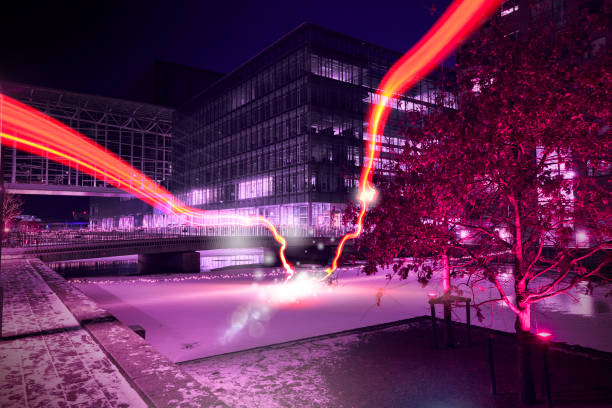 Red light runs through the residential area and hits the center in an explosion of light and energy. It is night, and the light trails light up in the dark. night photography, city lights, night,