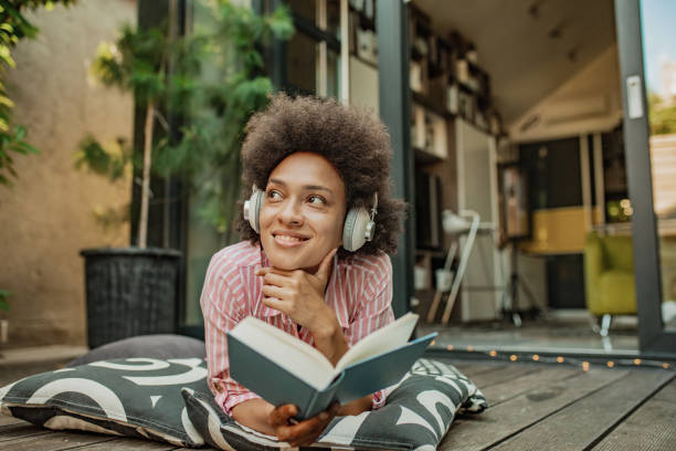Beautiful woman enjoying while reading a book at home