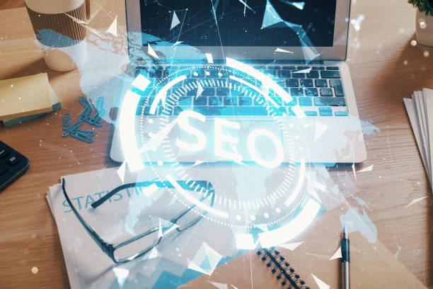 istock Double exposure of table with computer and seo drawing hologram. Search optimization concept. 1302686856