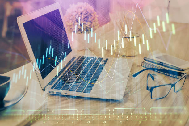 istock Double exposure of forex chart and work space with computer. Concept of international online trading. 1302687025