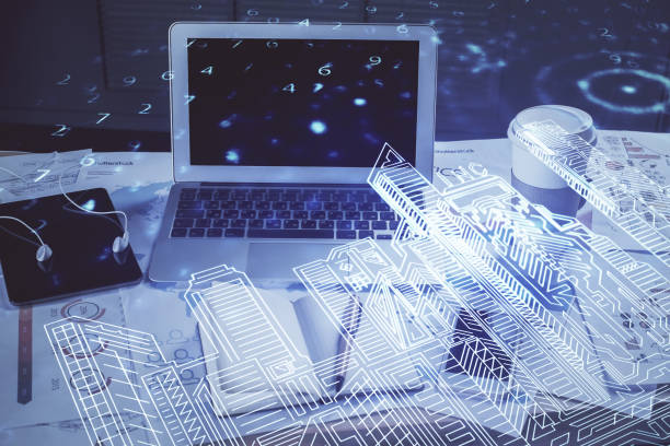istock Desktop computer background in office and big town buildings hologram drawing. Double exposure. Smart city concept. 1302687217