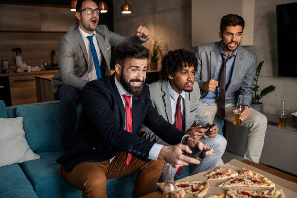 istock A group of young business man playing video games after work 1302687933