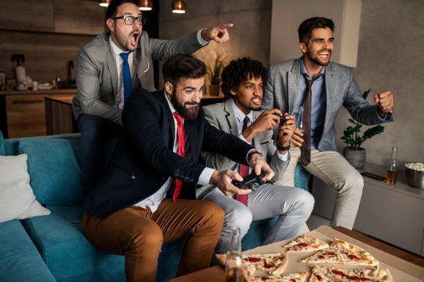 istock A group of young business man playing video games after work 1302688348