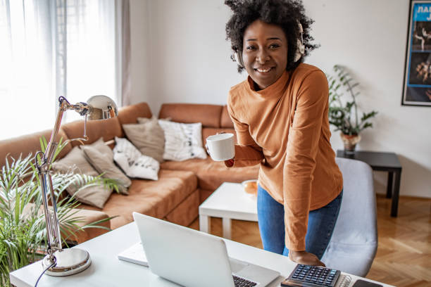 istock African American woman relaxing at home and using laptop 1302689575
