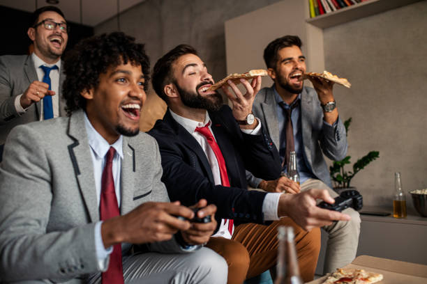 istock A group of young business man playing video games after work 1302689609