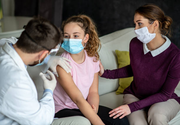 istock Young girl is sitting still while she gets vaccine. 1302690476
