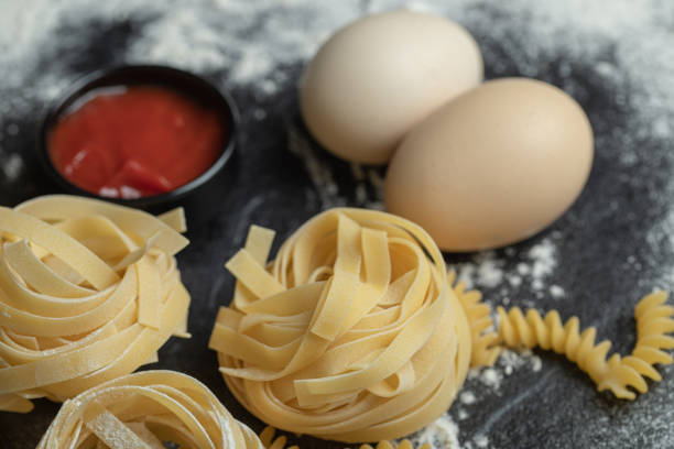 istock Raw nest noodles with flour on a dark background 1302690738
