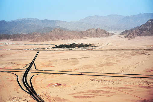 Aerial view from the plane on road junction in desert and mountains on Sinai Peninsula near Sharm El Sheikh, Egypt