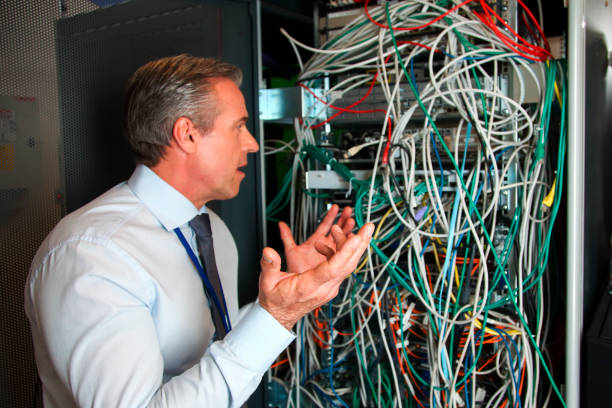 ネットワークの混乱を理解しようとしている女性エンジニア - messy network server cable computer ストックフォトと画像