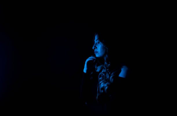 istock Woman blue neon lights in background. Space for your text. 1302695295