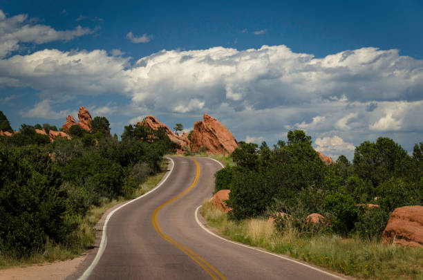 carretera pavimentada a través del parque conocido como jardín de los dioses en colorado - garden of the gods fotografías e imágenes de stock