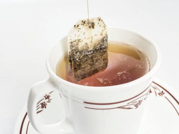 istock Tea cup and tea bag being steeped 1302697390