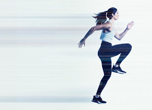 Female runner composite with streaks of lights and lines