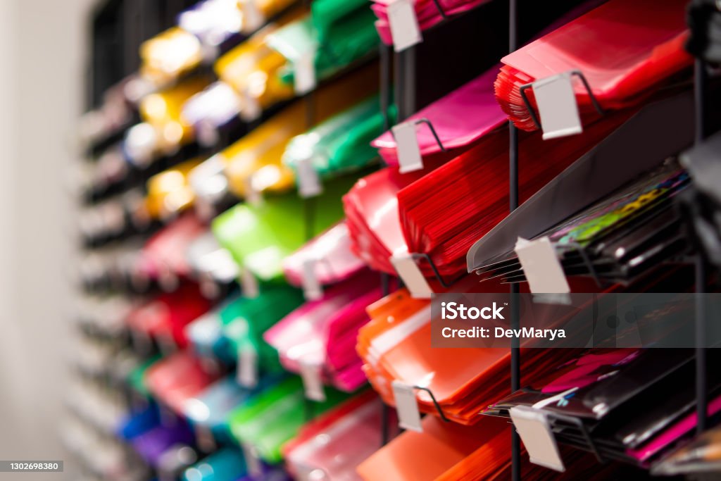 Plastic binder shelf in a shop. Binder sale. Multicolor stationery folders. Plastic binder shelf in a shop. Binder sale. Multicolor stationery folders Archival Stock Photo