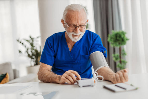 Doctor Doctor working in his office pressure gauge stock pictures, royalty-free photos & images