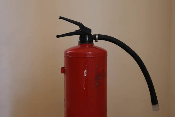 istock Red fire extinguisher top part on a white background. 1302700274