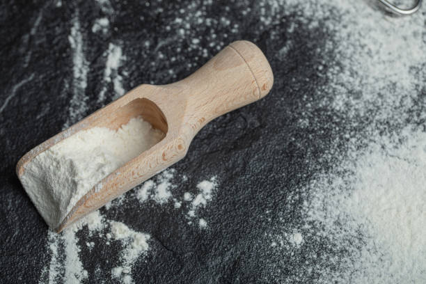 istock A wooden spoon with flour on a dark background 1302700400