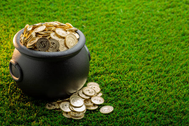 istock Bucket of Gold on Green Grass 1302702253