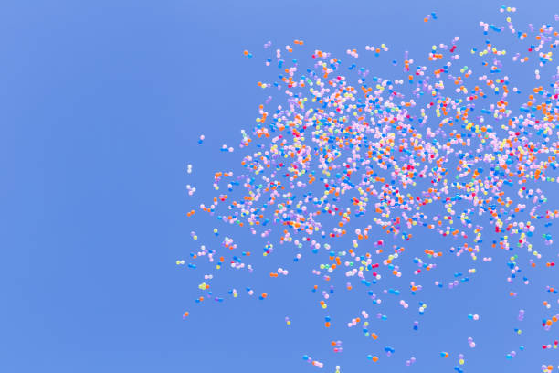 istock many colorful balloon flying in blue sky 1302705559