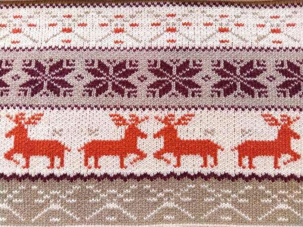 istock Real red knitted background with white Christmas deer and snowflakes 1302708125