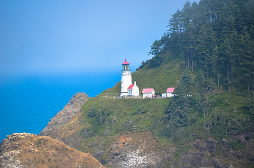 Oregon coast lighthouse incidental people outside are unrecognizable.