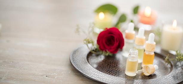 Essential Oils with a Rose and Candles